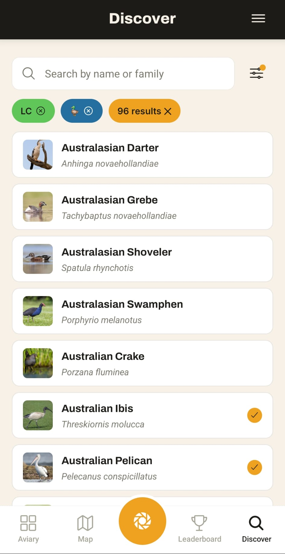 The Lifer Discover screen — a searchable list of bird species with photos and scientific names, ticks marking the ones already in your aviary