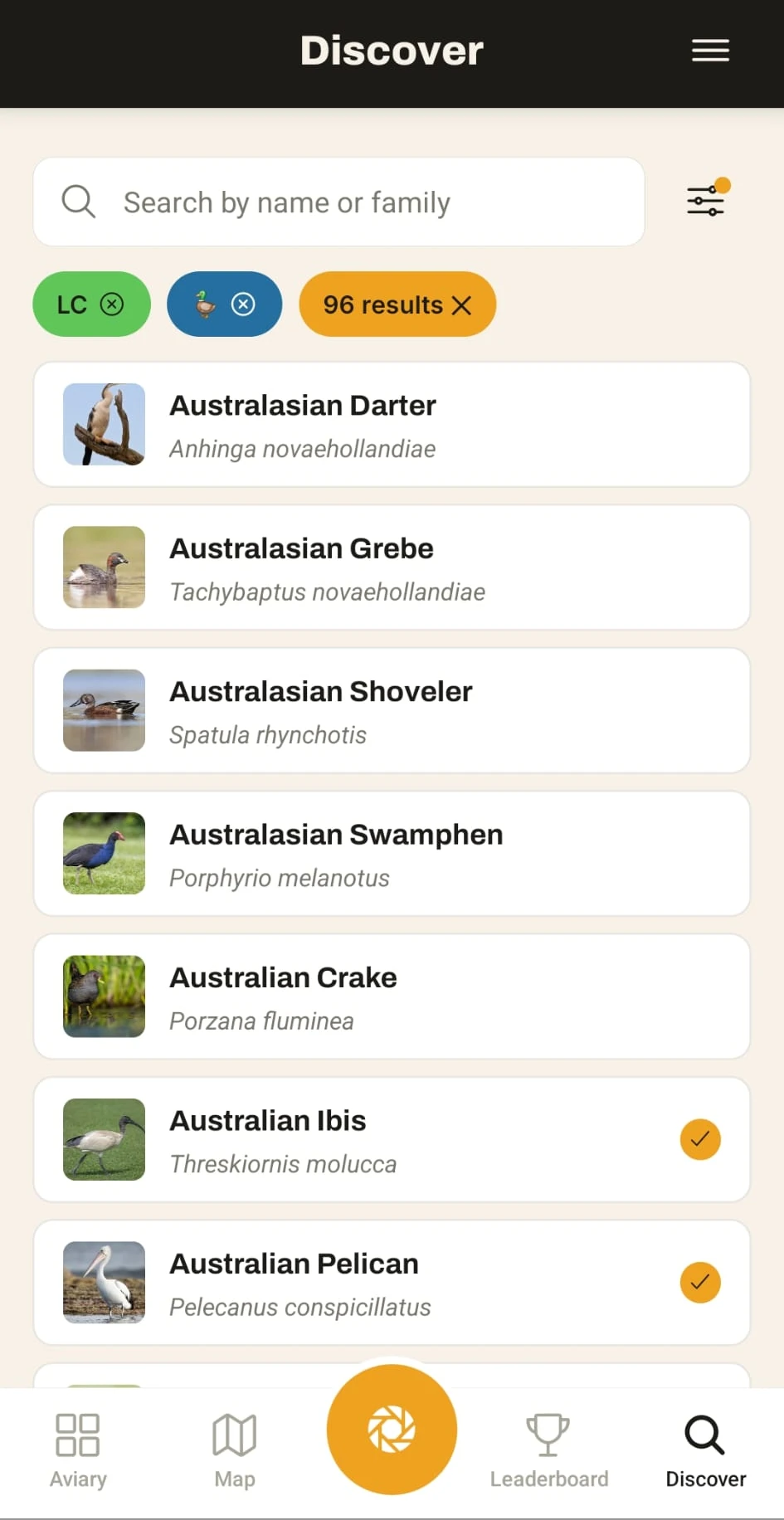 The Lifer Discover screen — a searchable list of bird species with photos and scientific names, ticks marking the ones already in your aviary
